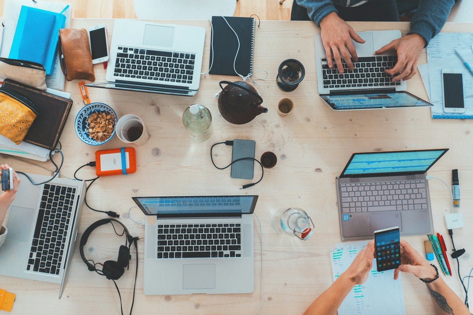 Designers working on laptops, seen from above